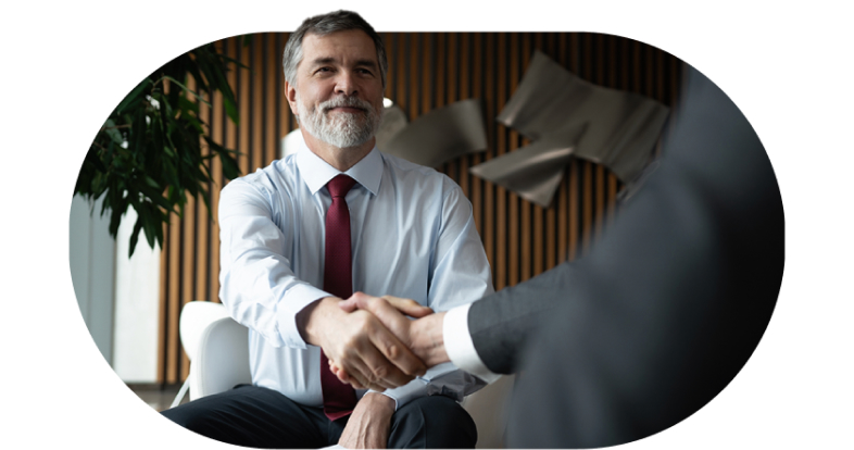 Two men shaking hands after securing partnership deal